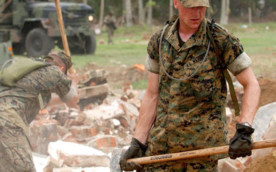 Okinawa-based Marines with the 9th Engineer Support Battalion demolish concrete walls in Galle, Sri Lanka, on Jan. 22, 2005, at a school severely damaged during the Dec. 26, 2004, tsunami.
