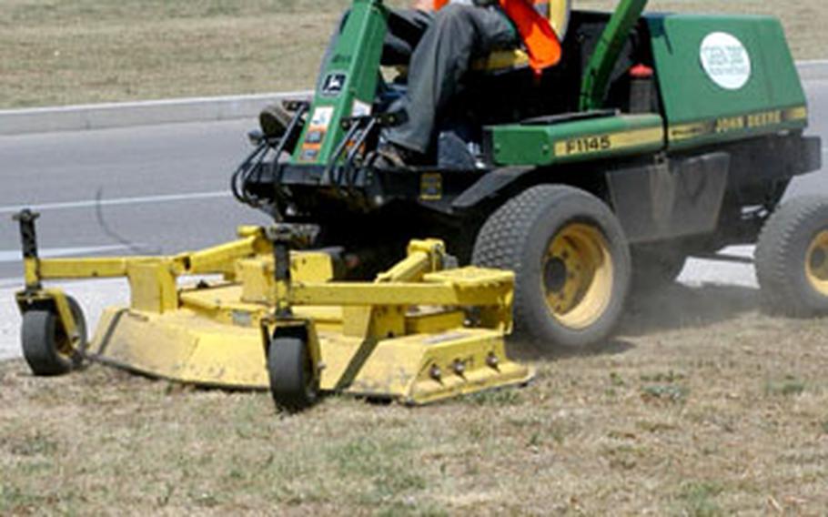 Enrico Leshner mows the lawn Tuesday in front of Aviano’s Building 1472. It didn’t take him too long, because a lack of rain has much of the grass turning brown.