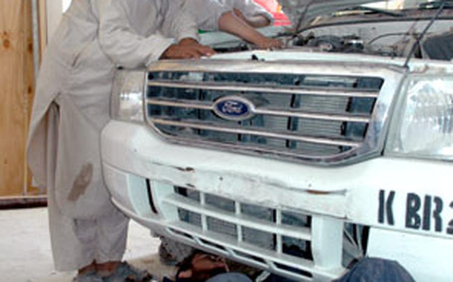 A group of Afghan students on Tuesday work on leaky lines in a truck during classes run by the Qalat provincial reconstruction team.
