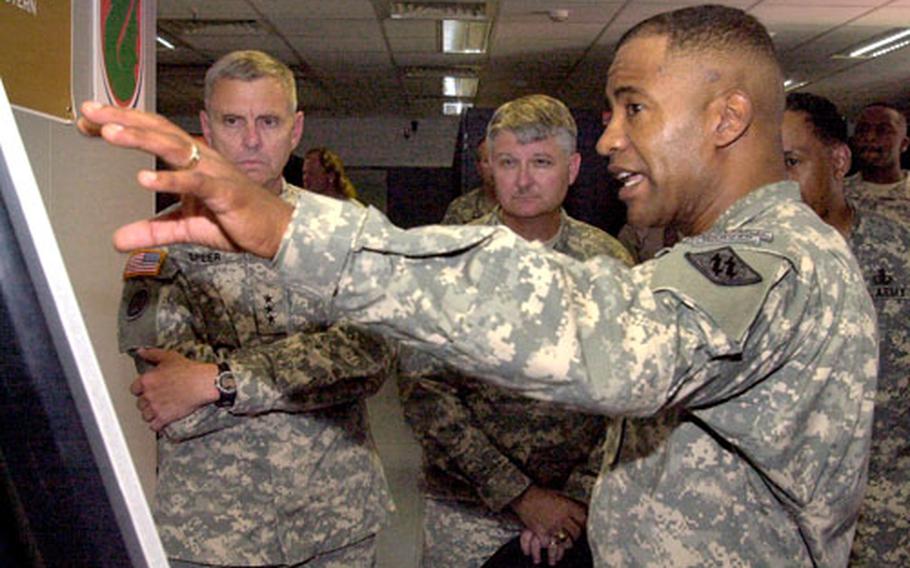 Army Col. Robert Ferrell, right, 2nd Signal Brigade commander, shows Lt. Gen. Gary Speer, left, deputy commanding general of U.S. Army Europe, how the 7th Army Area Processing Center in Kaiserslautern, Germany, fits into the Army’s computer network in Europe.