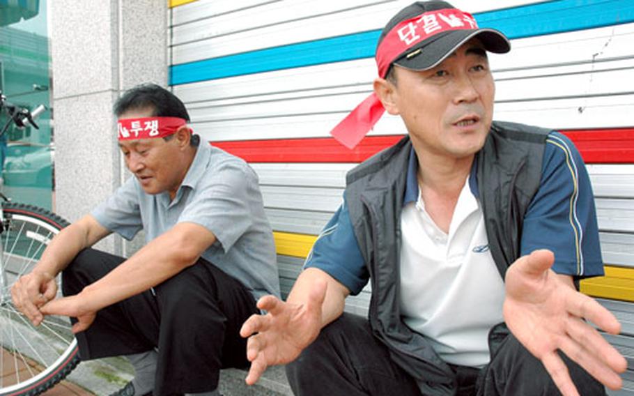 Park Byeong-hui, right, has been driving for Worldcup Arirang in Area I, Dongducheon and Uijeongbu, for 10 years. Park said he likes the work schedule as an on-base taxi driver but is worried the company doesn&#39;t invest enough in its workers or its taxi cabs.