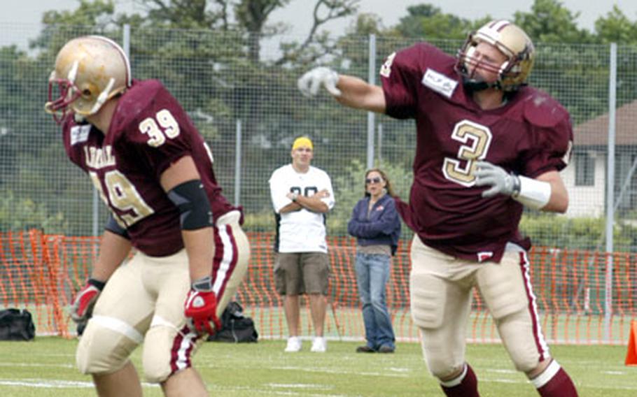MCP Ipswich Cardinals QB Staff Sgt. Shane Rhoades, an avionics technician with 48th Aircraft Maintenance Squadorn, throws a 37-yard touchdown pass in a recent game against the Kent Exiles.
