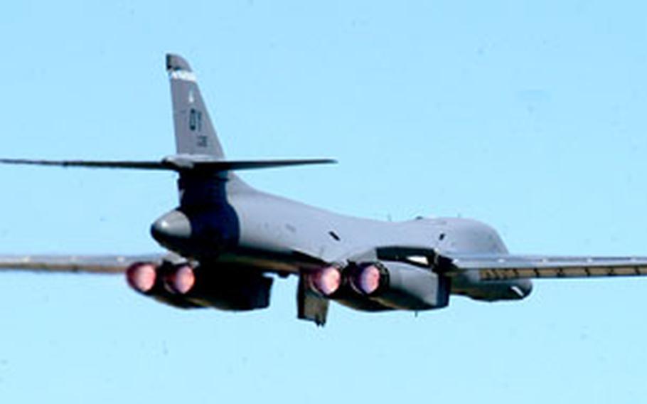 The afterburners of a B1-B Lancer glow as it takes off during the Royal International Air Tattoo.