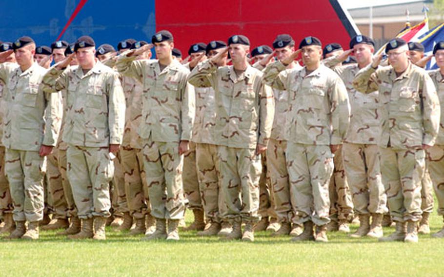 Soldiers of the 1st Military Intelligence Battalion salute during the playing of the national anthem at the welcome home ceremony.