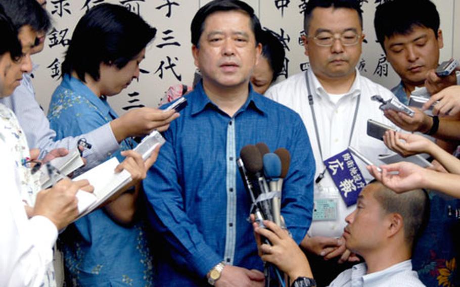 Japanese defense official Iwao Kitahara announces Thursday amid a throng of reporters that missiles will be deployed to Kadena Air Base.