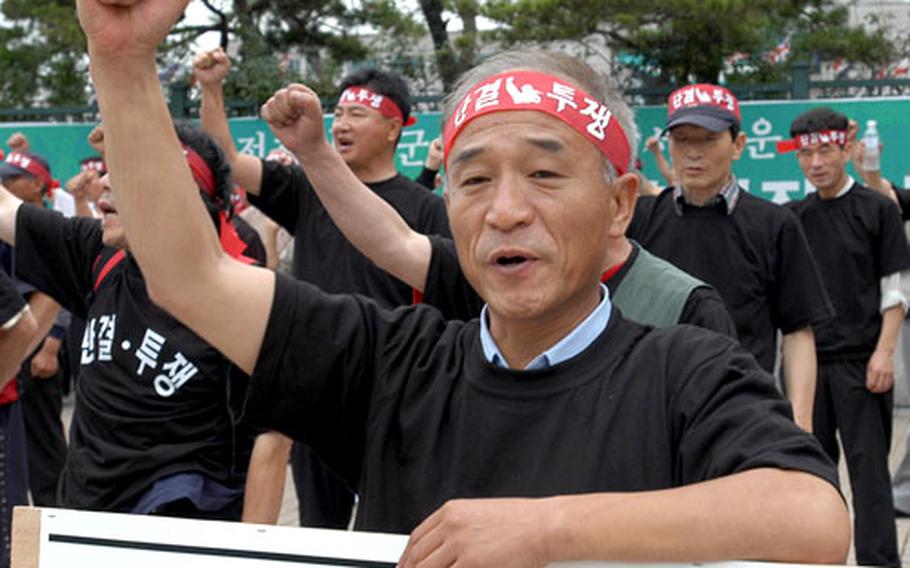 Taxi drivers from Area I and Area II protest outside Yongsan Garrison, South Korea, on Thursday.