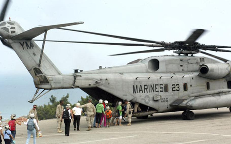 Evacuees from Beirut board a U.S. Marine helicopter Friday at the U.S. Embassy.