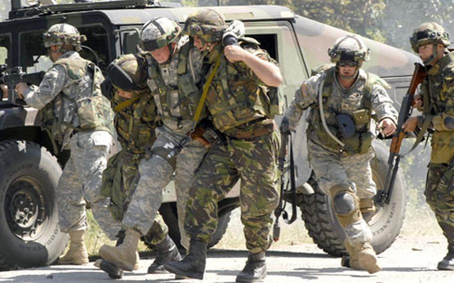 A squad of soldiers attempts to evacuate a "wounded" colleague to safety from the attack area of a convoy ambush training exercise held at the Novo Selo Training Area, Bulgaria.