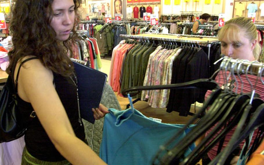 Raquel Girard, left, and Holly Pickerin check out clothing at Kaufland, a large shopping mall in Amberg.