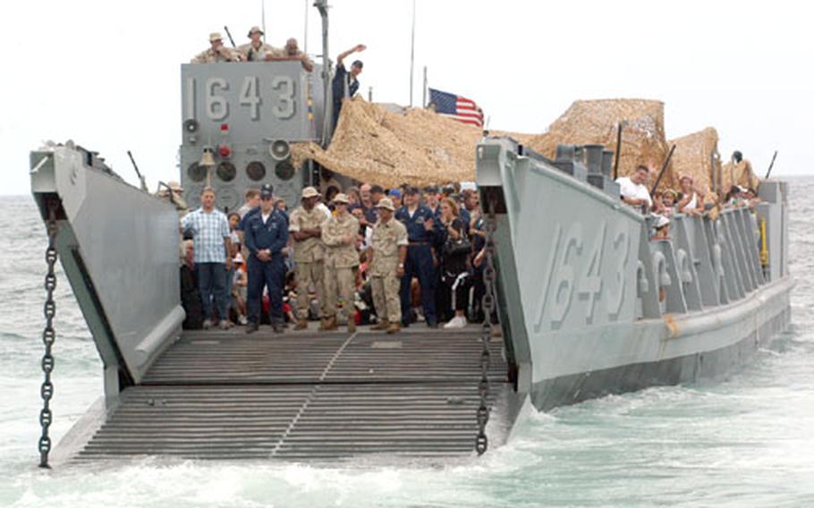 A landing craft loaded with evacuees pulls away from the beach in Beirut on Friday on its way to deliver U.S. citizens to the USS Trenton, which evacuated them to Cyprus.