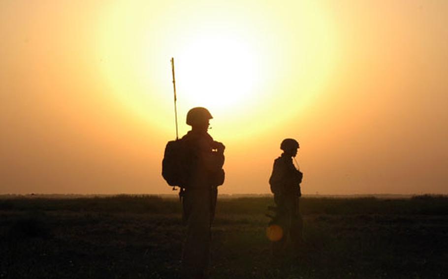 Marines with the 1st Combat Engineering Battalion prepare to search farmlands south of Fallujah for hidden weapons caches at dawn Sunday.