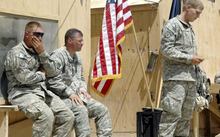 Spc. Jeff Hurst, right, speaks during a memorial service Monday for Sgt. Robert Kassin, killed in Afghanistan on July 16. Sgt. John Terry, left, tries to hold back his emotions, while Chaplain Capt. Timothy Thompson listens to the ceremony.