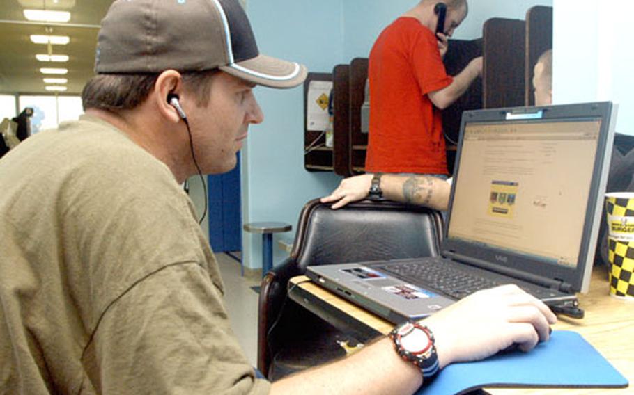 Petty Officer 3rd Class Steven Shepard uses the free wireless Internet connection on the third floor at Yokosuka’s Fleet Recreation Center Monday. There are about a dozen spots on base with free Wi-Fi access.