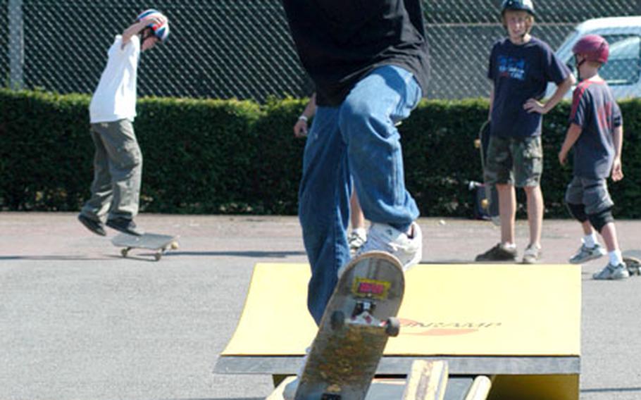 C.J. Chango, 12, ollies onto a rail as he practices a boardslide trick at RAF Mildenhall’s skatepark.