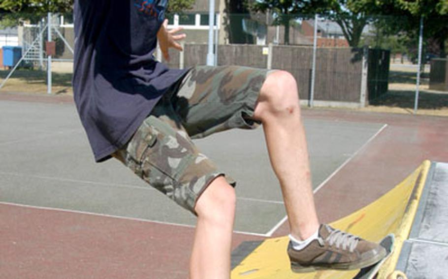 Logan Lawless, 14, attempts a 50-50 grind. Logan and other local youths participated in a USAFE Skateboard Camp last week.