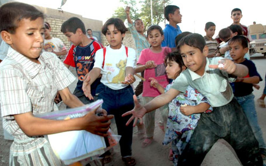 Children scramble for toys and treats in Fallujah.