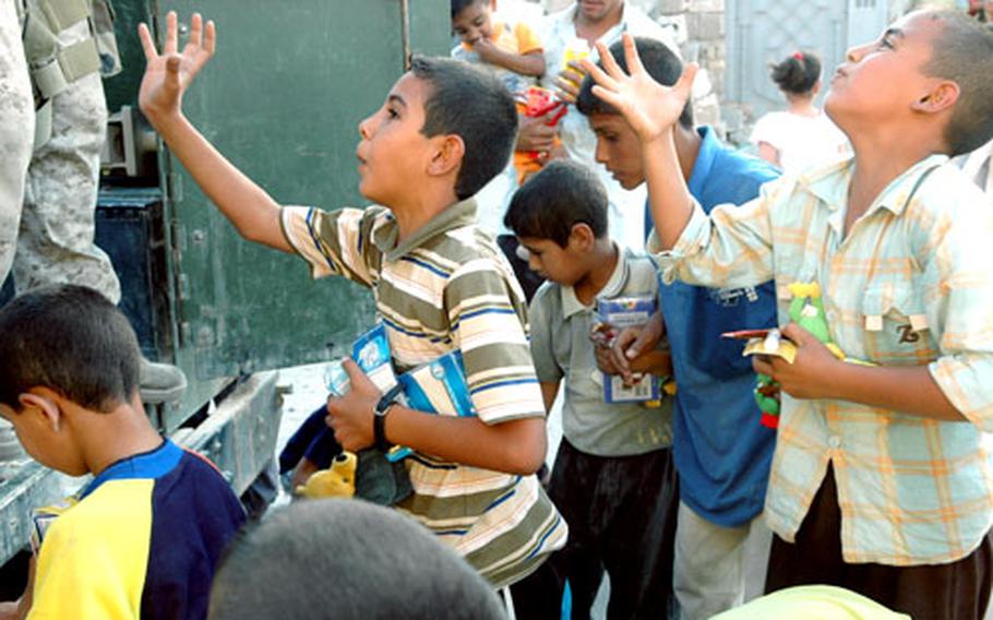 Iraqi boys plead for toys and candy.