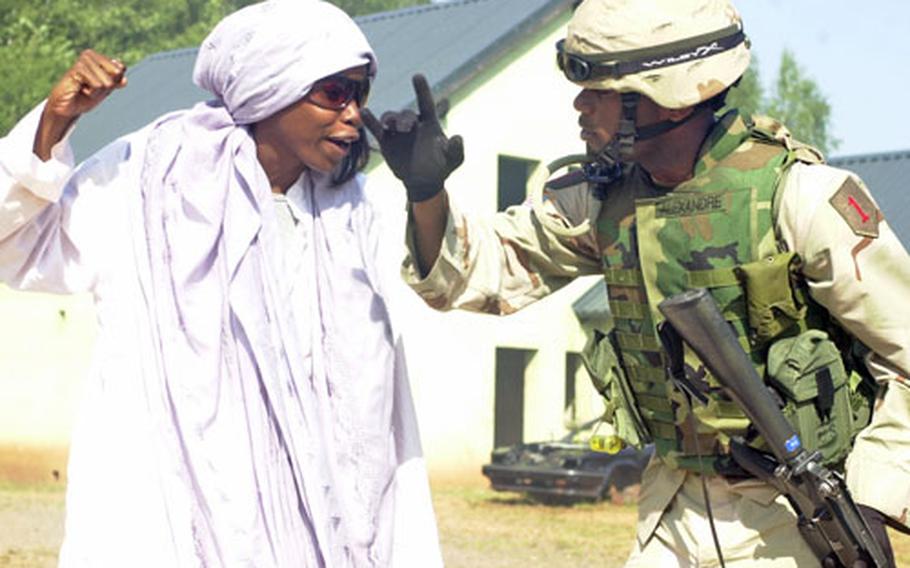 It was early in the day, but already Spc. Erikauh Mitchell, left, had accomplished her mission — so infuriating a soldier that he couldn’t complete his mission. Mitchell and others portray Iraqi villagers during training in Baumholder, Germany, for soldiers bound for Iraq. Recently, say fellow “Iraqi villagers,” Mitchell made one officer so mad the two had to be physically separated. “You just put yourself in the Iraqis’ place,” Mitchell said. “Sometimes you make people mad enough to hit you.”