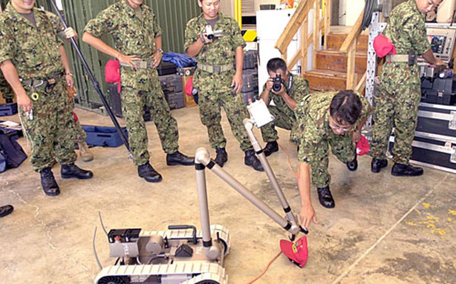 Japanese Self-Defense Force soldiers trained in explosive ordnance disposal put the U.S. Marine Explosive Ordnance Disposal Company’s newest lightweight robot through its paces at Camp Hansen on Tuesday as part of a two-hour visit.