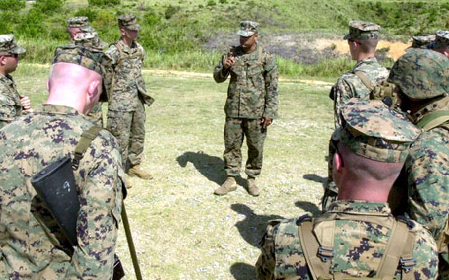 Weapons Platoon Marines listen to a safety briefing outlining the rules of the Camp Hansen range on Wednesday.