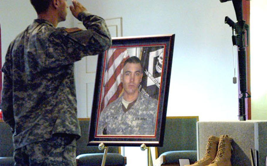 A soldier gives Sgt. Mark Vecchione a final salute following a memorial ceremony Wednesday afternoon in Friedberg, Germany.