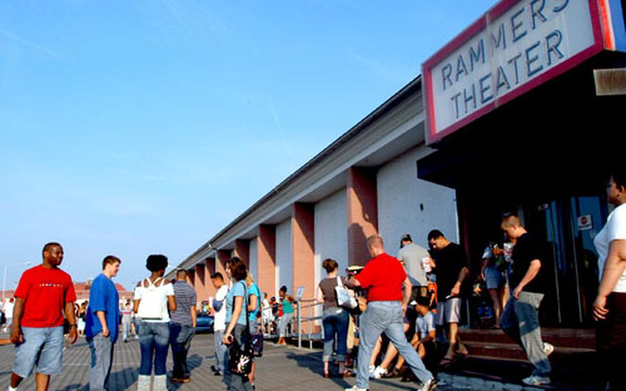 Moviegoers wait outside Rammers Theater after a fire alarm caused hundres of patrons to hoof it into the parking lot. "We&#39;re big movie people," said John Weiss, 27, who was at the theater with his wife. The couple goes to the movies once or twice a week. After the theater closes Friday, they will have to drive about a half hour to see English-language films.