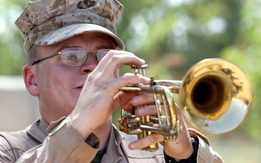 Cpl. Travis L. Anderson, a 20-year-old from Pinon Hills, Calif., plays “Taps” for Capt. Christopher T. Pate during a memorial service held Wednesday. Pate was killed in action July 21 and was honored in a memorial ceremony at Combat Outpost Dunlap, near Habbaniyah, Iraq.