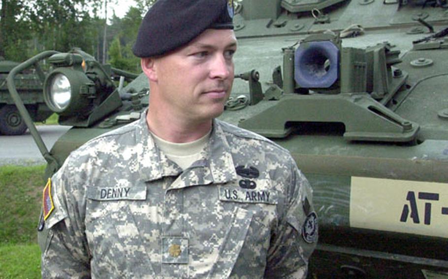 Maj. Bryan Denny, 39, of Oxford, N.C., 2nd Cavalry (Stryker) Regiment executive officer, talks to German reporters as 60 Stryker armored personnel carriers arrive at the Vilseck, Germany, railhead on Friday.