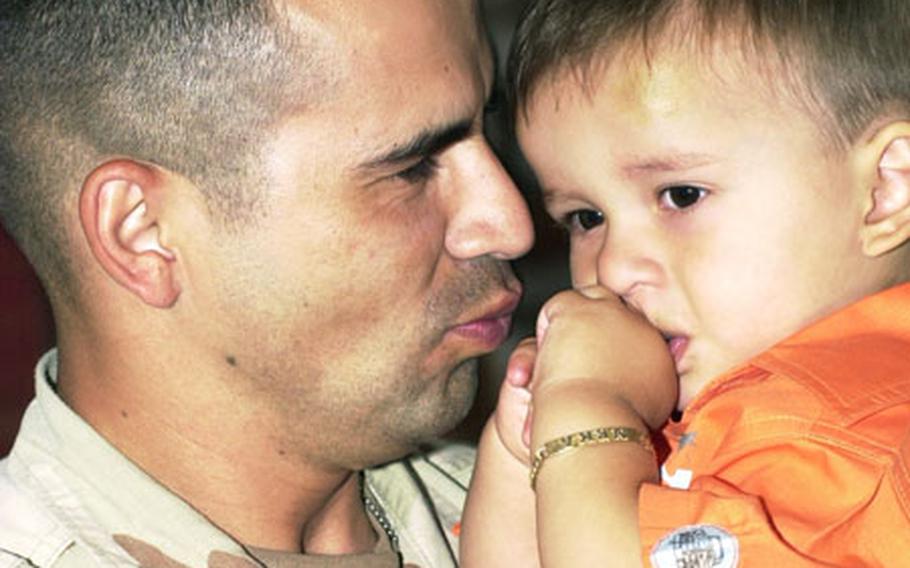 Sgt. Ismael Hernandez is reunited with his 16-month-old son, Neka, on Friday at Kleber Kaserne.