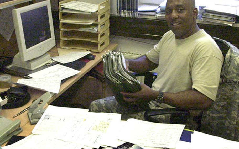Master Sgt. Douglas Clevester Jr., 38, was one of the first SJA staffers to arrive in Grafenwohr. Here, Clevester, of Houston, sorts through a clutter of files as he moved into his new office at the legal center.