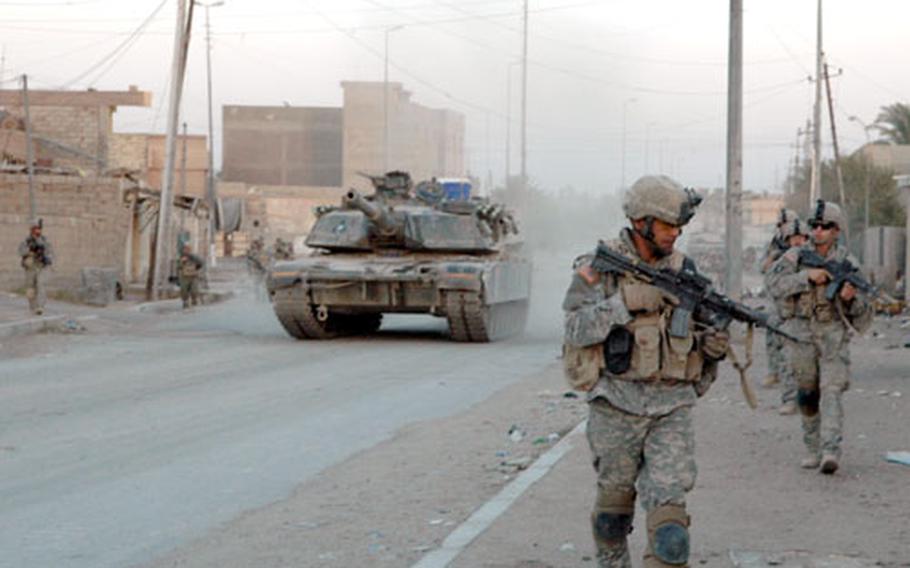Soldiers and tanks from 1st Battalion, 37th Armor Regiment leave Combat Outpost Falcon on a recent operation in downtown Ramadi.