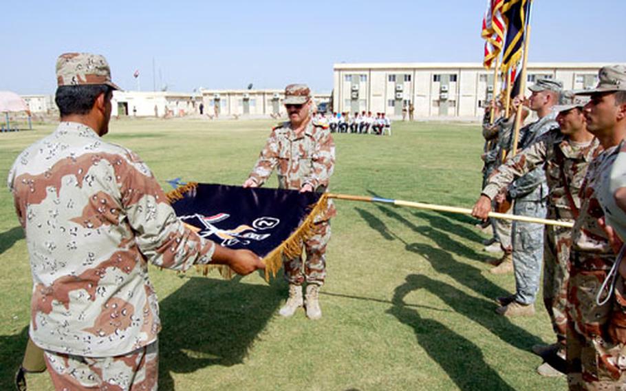 Maj. Gen. Anwar, commander of the 2nd Brigade, 4th Iraqi Army, uncases the brigade colors at a ceremony outside Kirkuk, Iraq. Iraqi troops took over security of a large section of Kirkuk at a Friday ceremony.