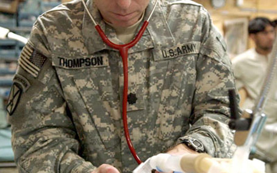 Dr. (Lt. Col.) Mark Thompson, a neonatalogist with the 14th Combat Support Hospital at Bagram Air Base, Afghanistan, examines a premature baby in the hospital's intensive care unit.