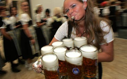 oktoberfest girl carrying beer