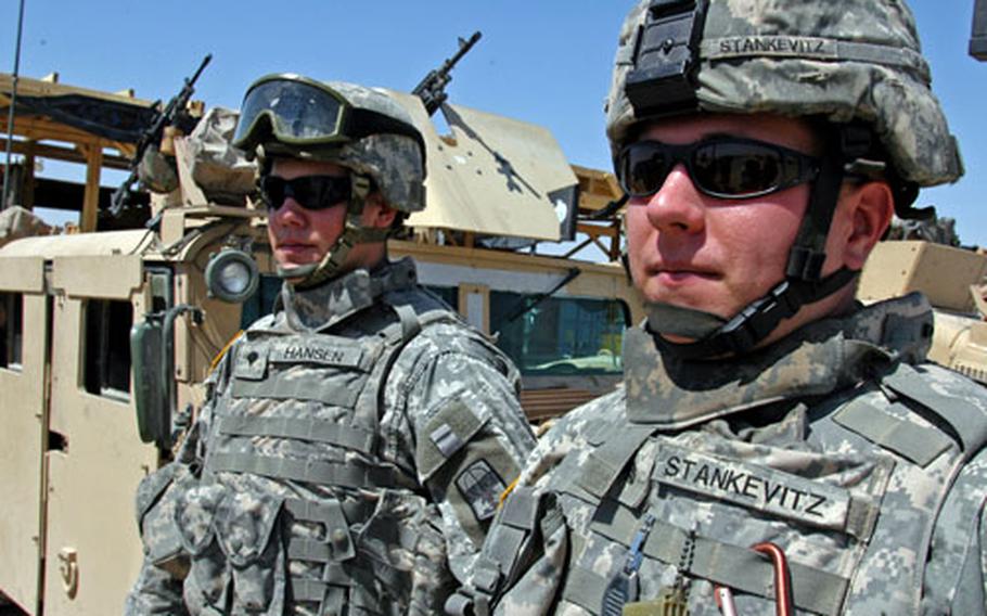 Sgt. Kyle Stankevitz, 24, right, and Spc. Donald Hansen, 20, members of the Wisconsin Army National Guard 1st Battalion, 121st Field Artillery, are among the soldiers at Camp Navistar, Kuwait, who drive gunner Humvees escorting convoys of supplies flowing daily from Kuwait into Iraq. Since July, the unit has logged about 900,000 miles.
