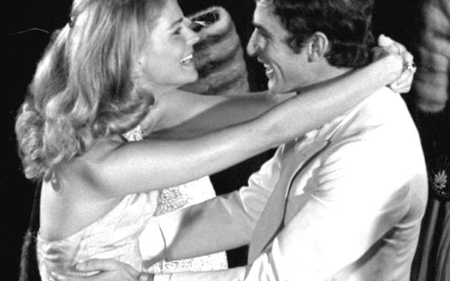 Candice Bergen and Bekim Fehmiu dance during the filming of a scene from "The Adventurers."