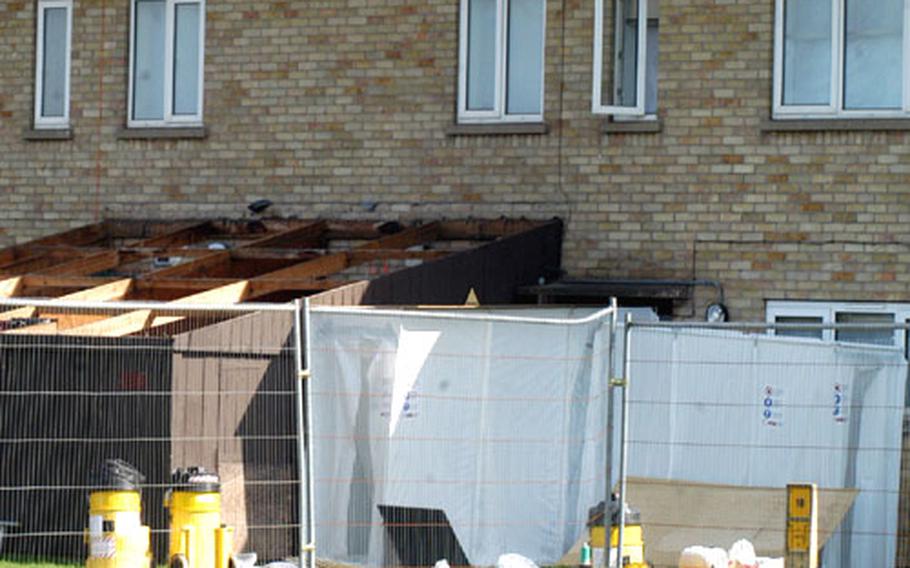 Equipment from Antec, an asbestos removal company, sits outside an abandoned building where asbestos was removed Wednesday on RAF Lakenheath, England.