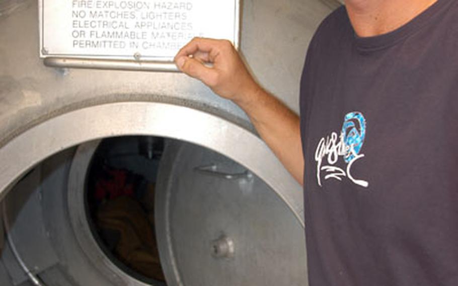 Staff Sgt. Joshua West, a diver with the Army’s 544th Engineer Team (Dive) in Kuwait, stands by one of two decompression chambers located at Camp Patriot, Kuwait. As the only team of Army divers operating in Central Command, the soldiers often conduct missions in Iraq that include aircraft and body recovery, bridge demolition, reconnaissance and removal.