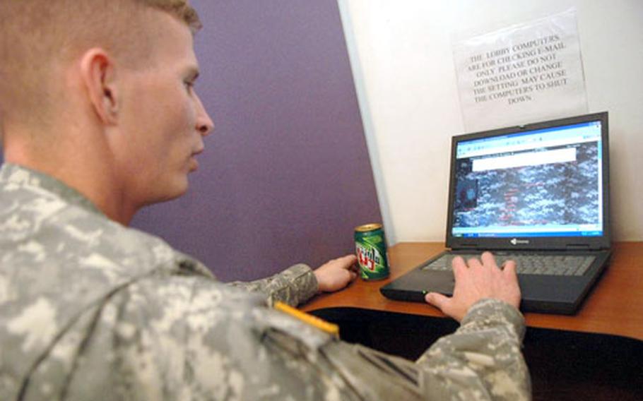 Spc. Brian Bailey, 26, checks his MySpace page, which he's decorated with combat uniform-patterned camouflage.