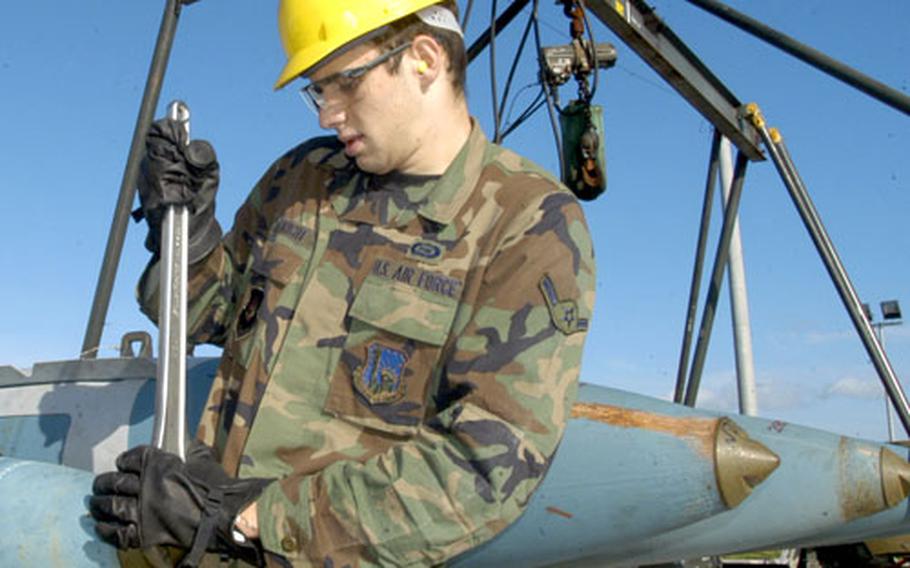 Airman Jason Searight of the 48th Operational Support Squadron tightens the nose tip of a 500-pound dummy bomb while participating in the Lakenheath Combat Munitions Assembly Course on Thursday.
