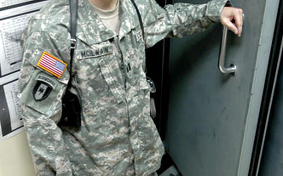Capt. David McIlwain, the lone American military audiologist in Iraq, stands in front of his soundproof testing booth at the 10th Combat Support Hospital in Baghdad’s Green Zone.