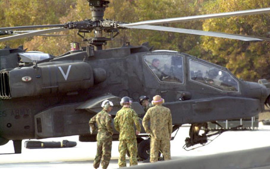 Australian soldiers observed Tuesday as 2nd Combat Aviation Brigade soldiers fueled and loaded ammunition on Apache helicopters at Rodriguez Range, South Korea.