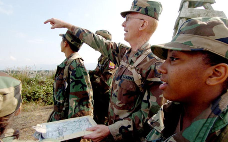 Retired Lt. Col. Robert F. Mateer III, the senior Army instructor for the Yokota JROTC, issues coordinates for the start of an orienteering course at Camp Fuji, Japan.