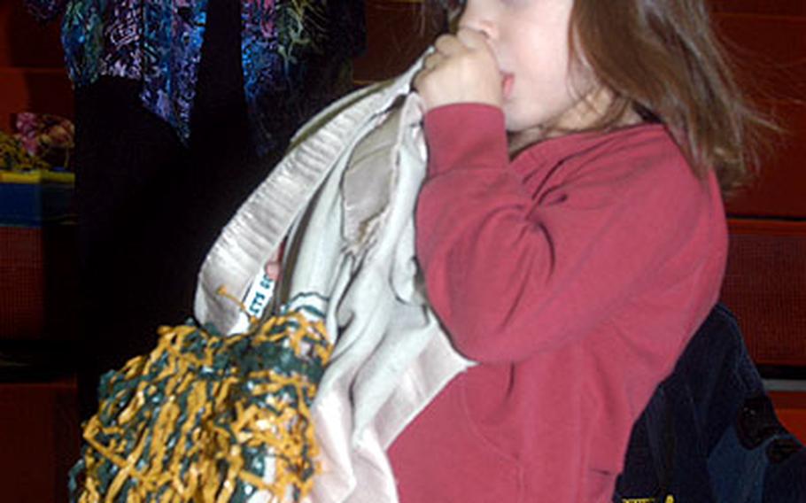 Waiting for daddy can be taxing, especially when it’s way, way past your bedtime, as it was for this 4-year-old when the 709th Military Police Battalion returned to Fliegerhorst Casern shortly after 2 a.m. Thursday. With binky and pompom well secured, Victoria Lutz casts a lasting glance for her dad, Capt. Gene Lutz, commander of the Headquarters and Headquarters Detachment.
