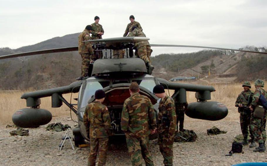 At a training range in South Korea in February 2005, soldiers of the 2nd Battalion, 52nd Aviation Regiment do maintenance on a UH-60 Black Hawk helicopter. The battalion, part of the 2nd Combat Aviation Brigade, will get a new name Monday at Camp Humphreys.
