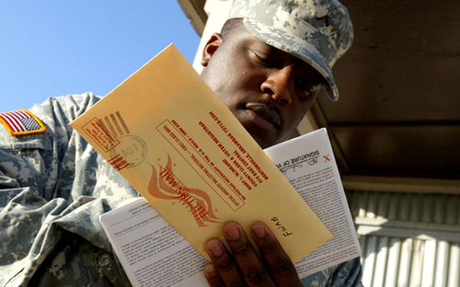 Pvt. Samuel C. Jackson, 26, of The Colony, Texas, holds his absentee ballot before he mails it from a post office at Camp Bondsteel in eastern Kosovo last week.