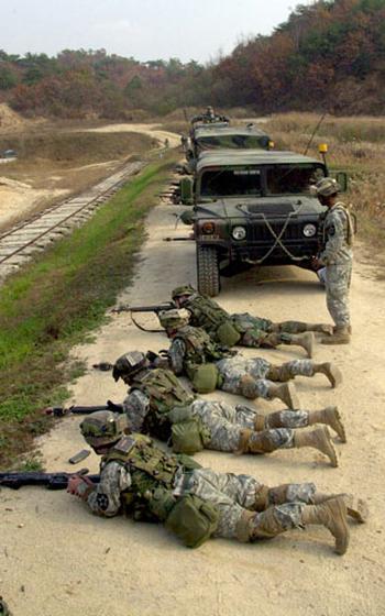 Soldiers from the 2nd Combat Aviation Brigade’s 4th Battalion, 2nd Aviation Regiment react to pop-up targets and opposition fire with blank rounds Friday at Rodriguez Range, South Korea, in preparation for a live-fire exercise.