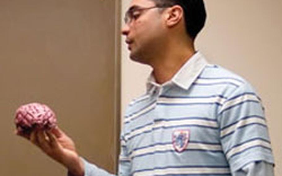 Spc. Hugo Gonzalez, who was wounded in Iraq, gives a presentation about the brain and the effects of traumatic brain injury to fellow patients during a speech pathology TBI group session at Walter Reed Army Medical Center in Washington, D.C.