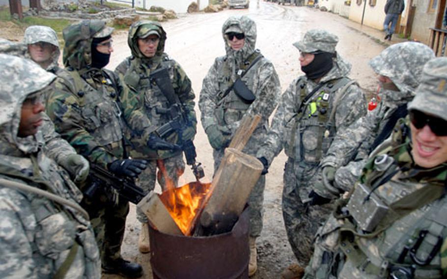 Virginia Army National Guard soldiers try to stay warm during training at Hohenfels, Germany, on Sunday.