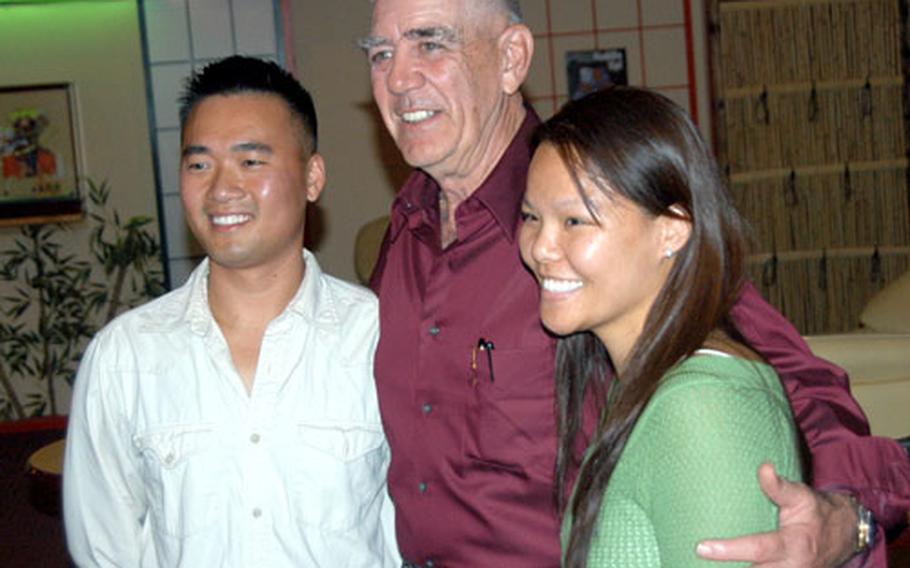 R. Lee Ermey, center, actor and former Marine Corps drill instructor, poses with Marine Staff Sgt. Phong Nguyen and his wife, Kim, during a visit to the Yokota Officers’ Club in 2006.
